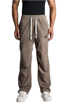 My Store ALO track pants in taupe with an elastic waistband, drawstring, and logo detail on a male model