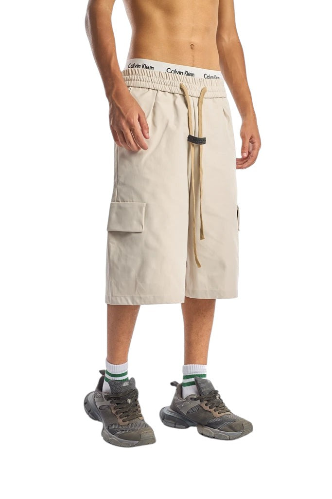 My Store beige cargo shorts with elastic waistband and drawstring, worn by a model with sneakers