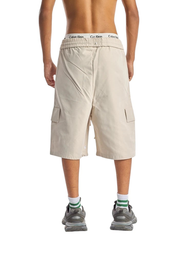 My Store beige cargo shorts with an elastic waistband worn by a model, back view.