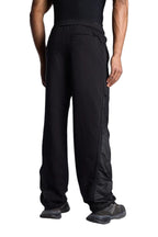 Back view of a man wearing My Store black Off-White sweatpants with mesh side panel detailing.