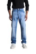 My Store relaxed fit mid blue denim jeans worn by a model with a black shirt and white sneakers