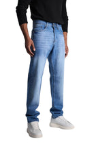 My Store relaxed fit mid blue denim jeans worn by a man with a black long-sleeve shirt and white sneakers