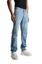 My Store relaxed fit jeans in a light sky blue washed denim worn by a man with white sneakers