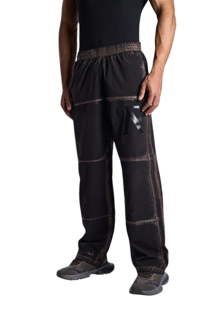 My Store Represent black sweatpants with a distressed grid pattern and elastic waistband worn by a male model