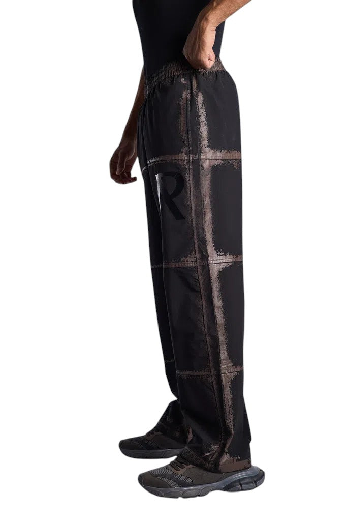My Store Represent sweatpants in black with a distressed grid print and elastic waistband worn by a model