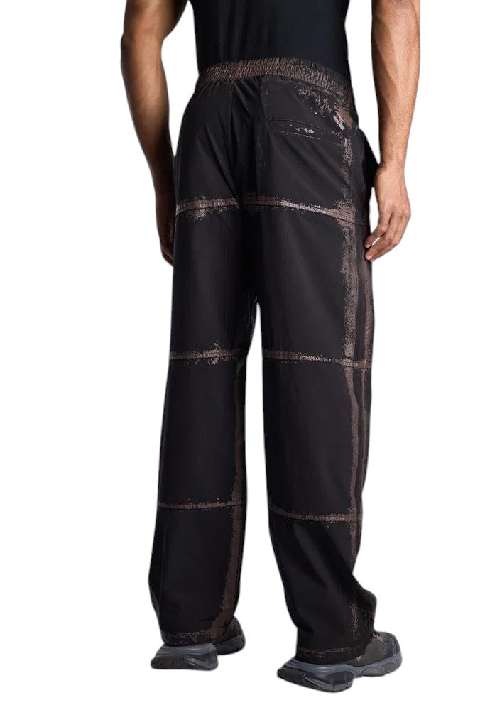 My Store Represent sweatpants in black with a distressed grid pattern, featuring a relaxed fit and elastic waistband.
