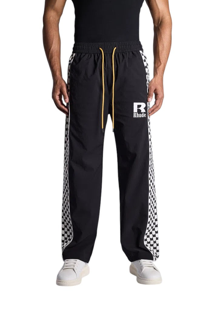 My Store Rhude black track pants with white checkered side stripes, elastic waist, and yellow drawstring