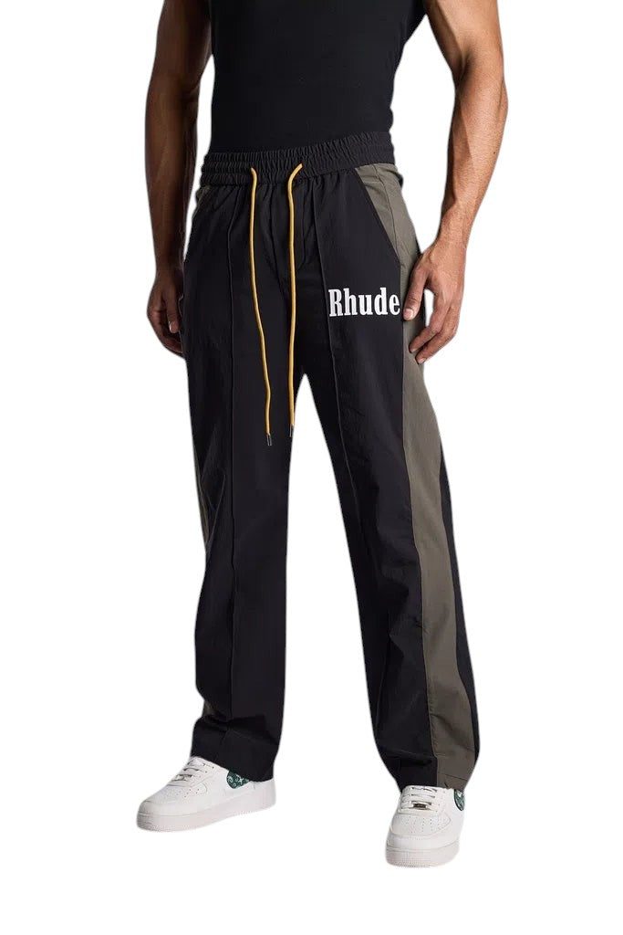 My Store Rhude black and green Aerial track pants with white logo and yellow drawstring worn by a male model