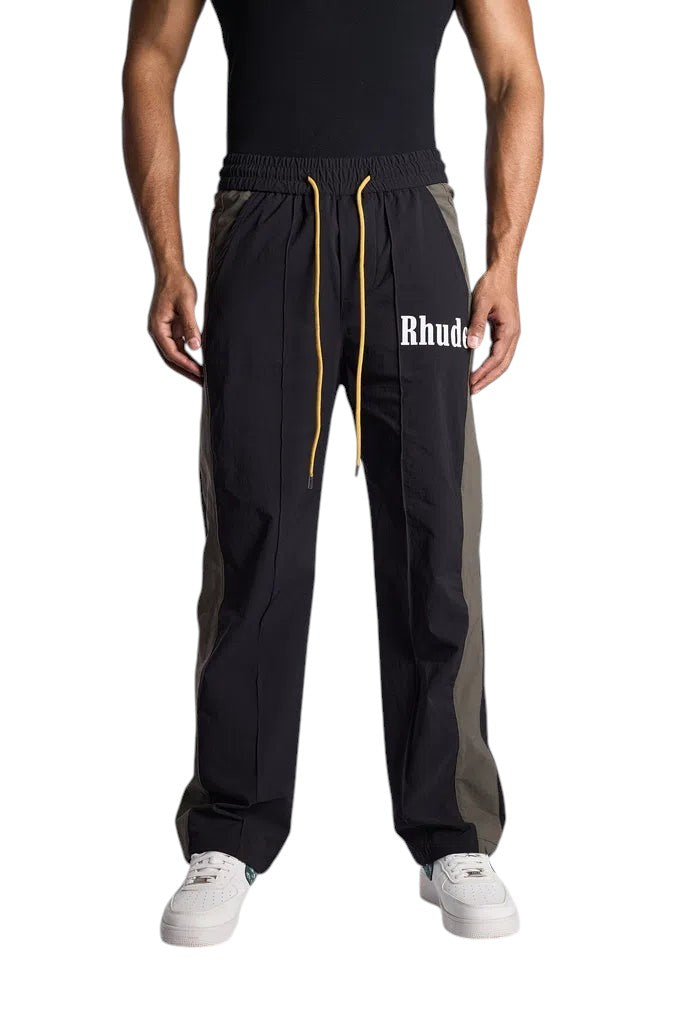 My Store Rhude black and green Aerial track pants with white logo and yellow drawstring on a model
