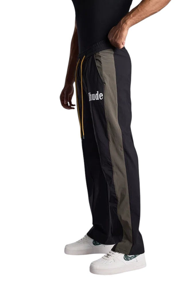 My Store Rhude black and green Aerial track pants with white logo and yellow drawstring, side view
