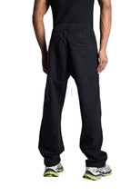 My Store Rhude wide leg black denim jeans worn by a man from the back view, featuring an elasticated waistband.