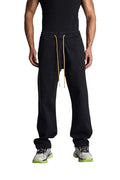 My Store Rhude wide leg black denim pants with an elastic drawstring waist and yellow laces worn by a male model
