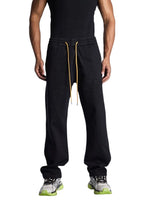 My Store Rhude wide leg black denim pants with an elastic drawstring waist and yellow laces worn by a male model