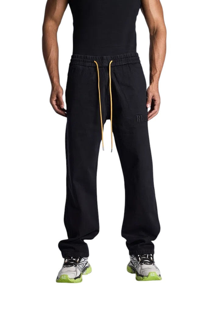 My Store Rhude wide leg black denim pants with an elastic drawstring waist and yellow laces worn by a male model