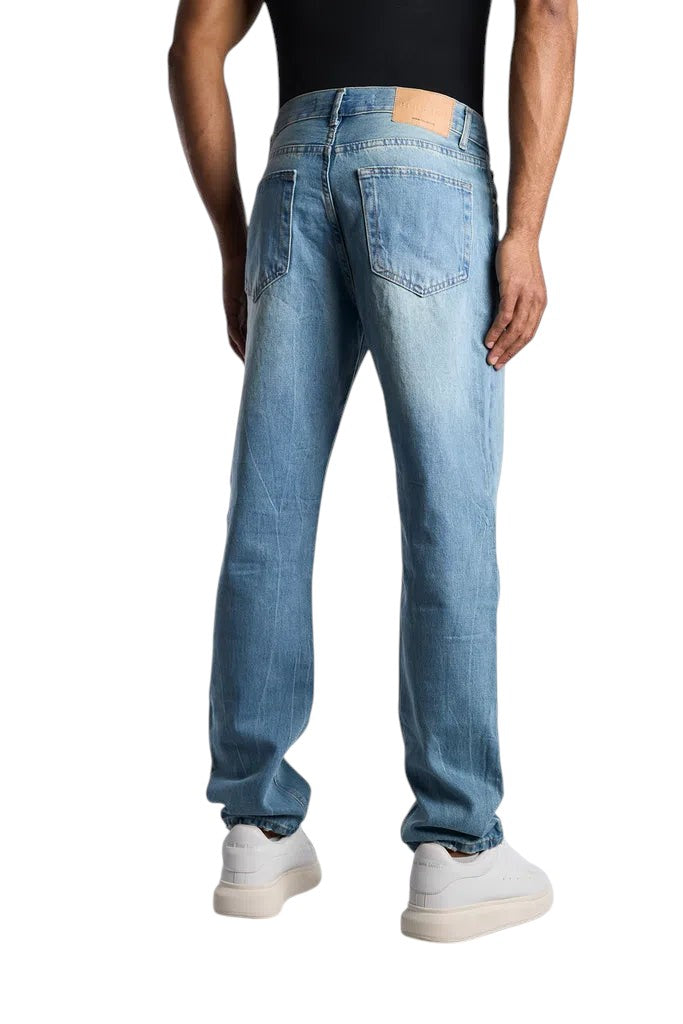 My Store relaxed fit jeans in sky blue washed denim worn by a man from the back view with white sneakers