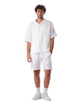 My Store white linen short set featuring a short-sleeved button-down shirt and matching shorts on a male model